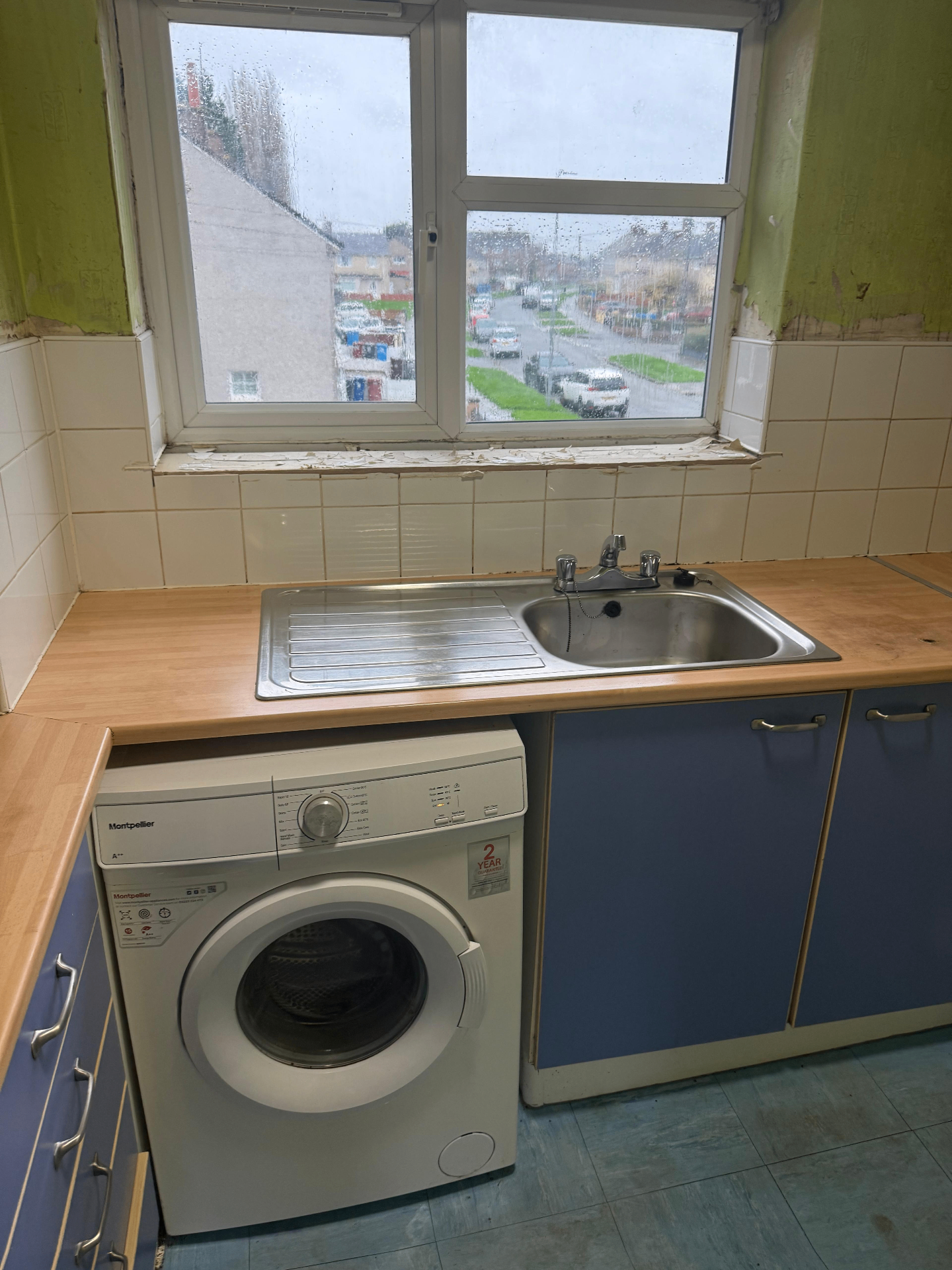 After clearance: same kitchen with floor, sink and worktops cleared and wiped down, ready for follow-on works