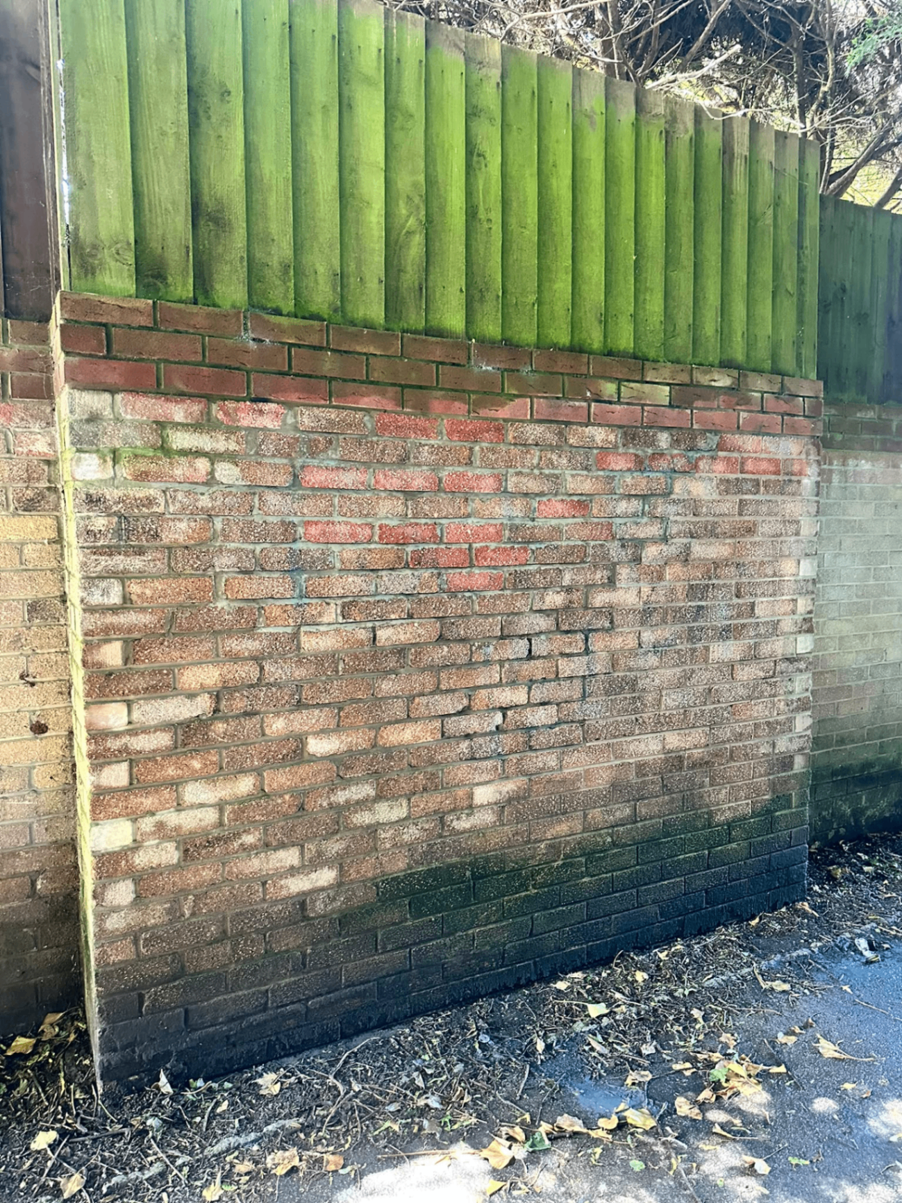 After graffiti cleaning: the tagged brick wall cleaned back to its original appearance